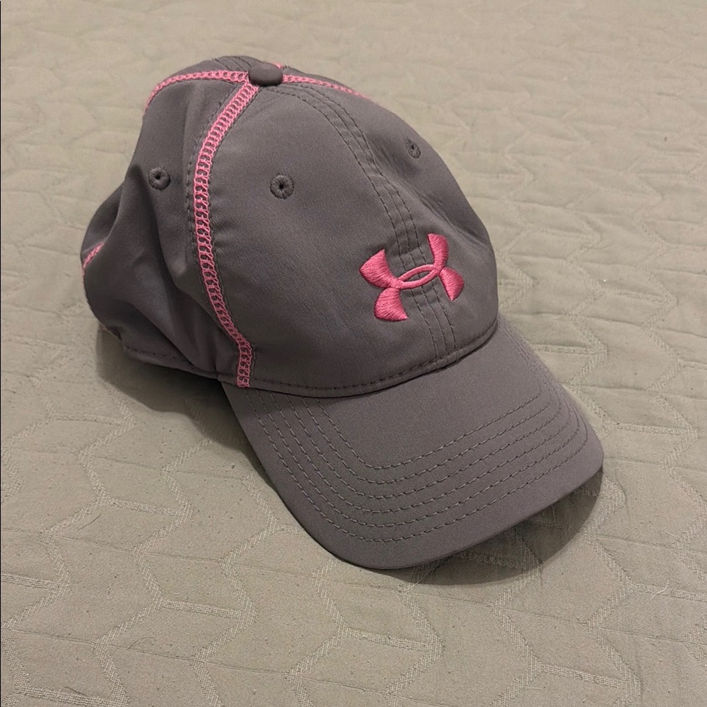 Under Armour Gray Cap with Pink Logo. Adjustable strapback. Ponytail opening.